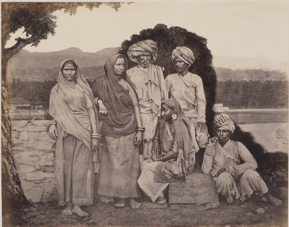 Photograph of six India people under a tree