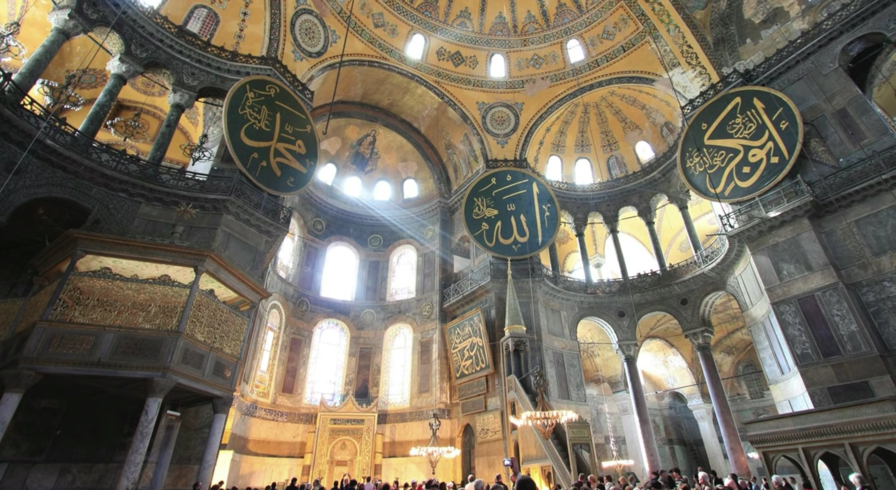 Interior view of Hagia Sophia with light streaming through the windows of the apse.