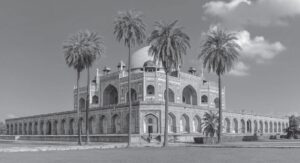 photo of a large palace with rounded ceilings, with palm trees in front of the palace