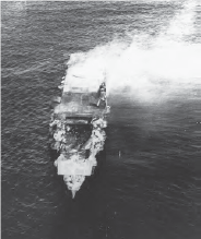 Image capturing a large Japanese carrier ship engulfed in flames while positioned in open water.