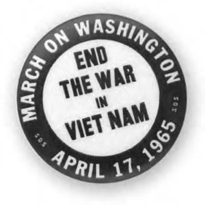 image of a pin that says "march on washington, End the war in Vietnam, April 17, 1965"