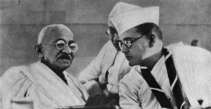 Photograph of Gandhi and Bose talking together. 