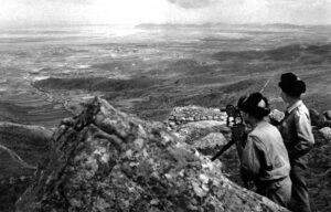 people taking photos of a distant valley